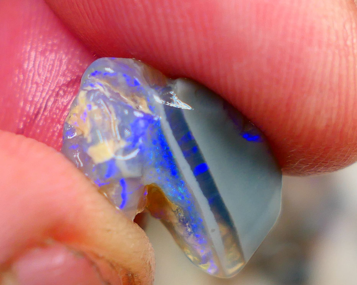 Lightning Ridge Rough Opal 6.00cts Crystal opal carrying fire sat on a bar with blues sat on dark base mother nature hey? Sold as gamble 17x10x7mm Auciton168